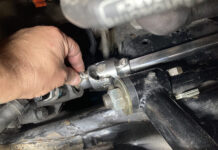 1967 Chevelle Steering Shaft Install Hand aligning the lower universal joint and polished Double D shaft onto the steering box splines next to the tubular control arm mount.