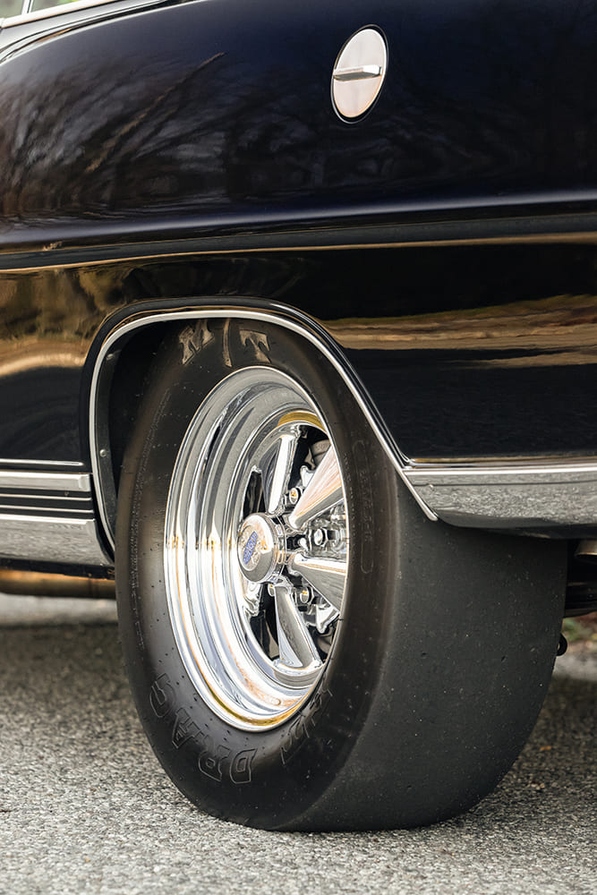 Rear quarter view of a wide chrome Cragar S/S wheel wrapped in a fat Mickey Thompson drag slick tucked cleanly inside the fenderwell.