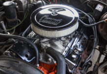 Overhead view of the finished small-block Chevy engine bay showcasing the round chrome Summit air cleaner, matching chrome valve covers, and tidy hose routing.