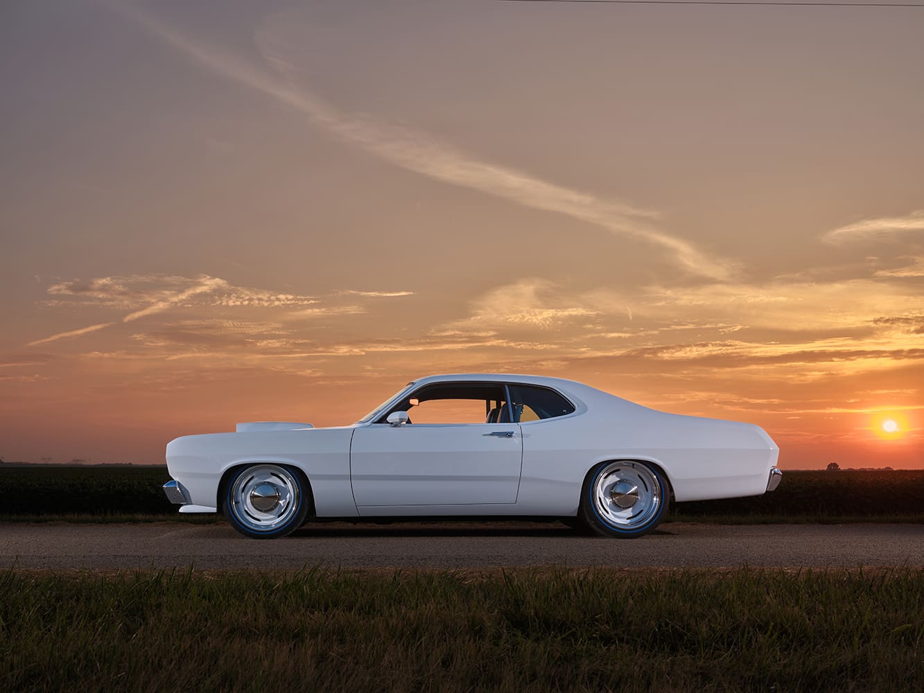 1971 Plymouth Duster side profile white paint sunset background clean custom stance classic muscle coupe