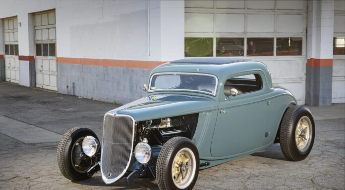 A Father’s Blueprint Becomes a Son’s 1933 Ford Coupe Low-angle front view of a slate blue-teal chopped 1933 Ford 3-Window Coupe highlighting the exposed front suspension and open engine bay.