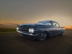 1959 Chevrolet Impala low angle front driving photo blue custom coupe sunset road motion blur