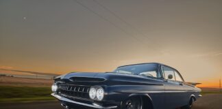 1959 Chevrolet Impala low angle front driving photo blue custom coupe sunset road motion blur