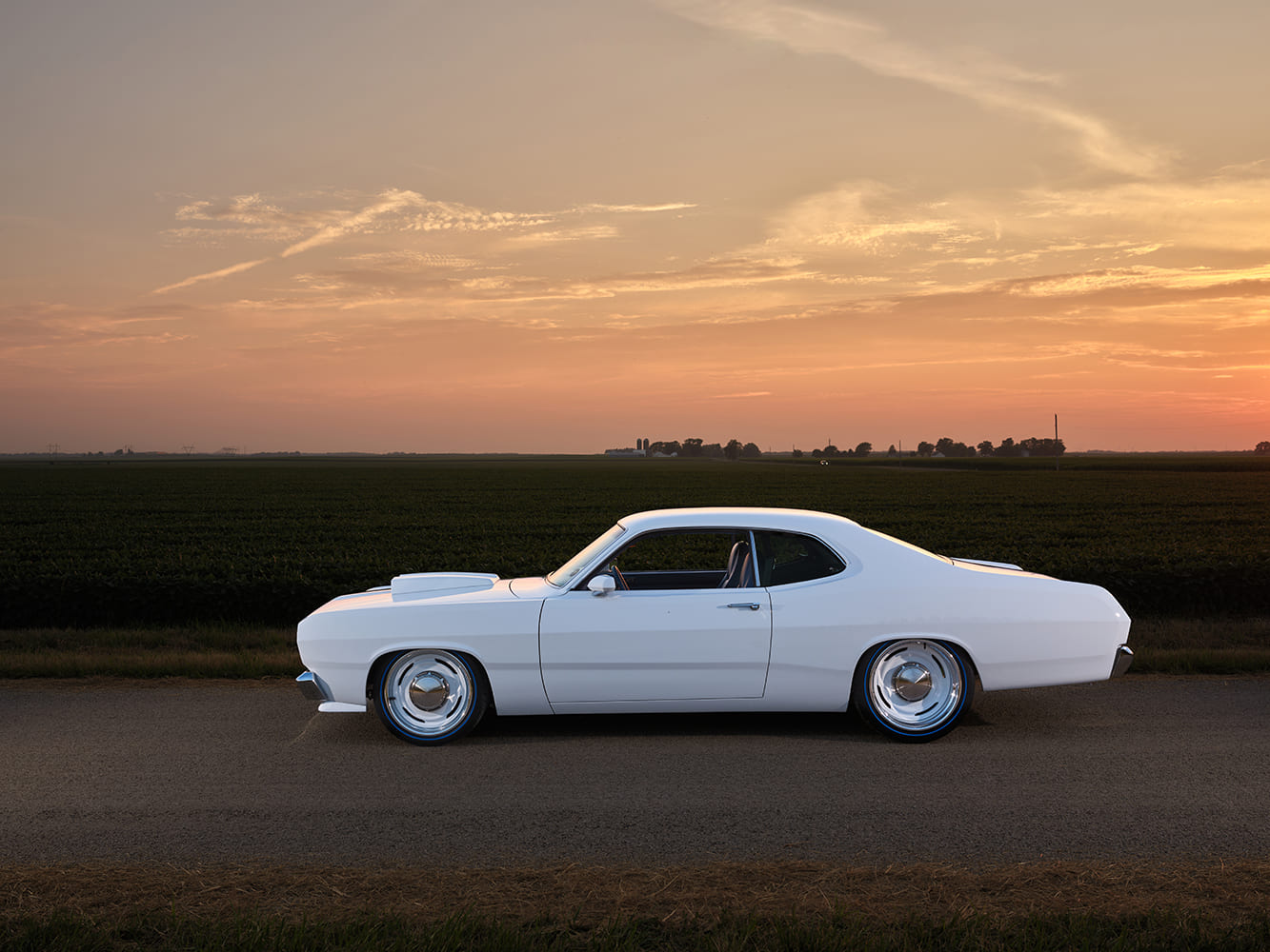1971 Plymouth Duster white custom parked roadside sunset side view shaved body pro touring build