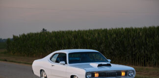 1971 Plymouth Duster white custom front view roadside cornfield headlights on pro touring muscle car