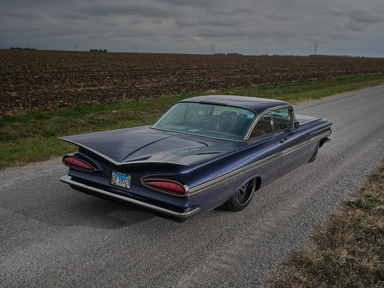 1959 Chevrolet Impala rear three quarter parked view blue custom coupe tailfins chrome trim rural road