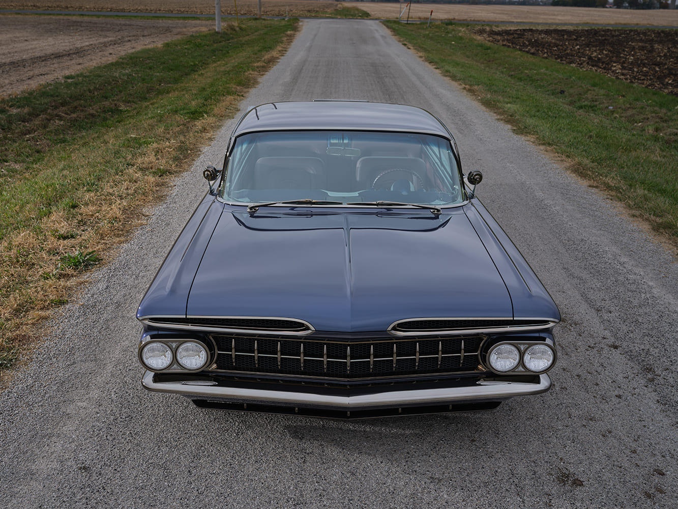 1959 Chevrolet Impala front head on view custom grille quad headlights blue coupe country road