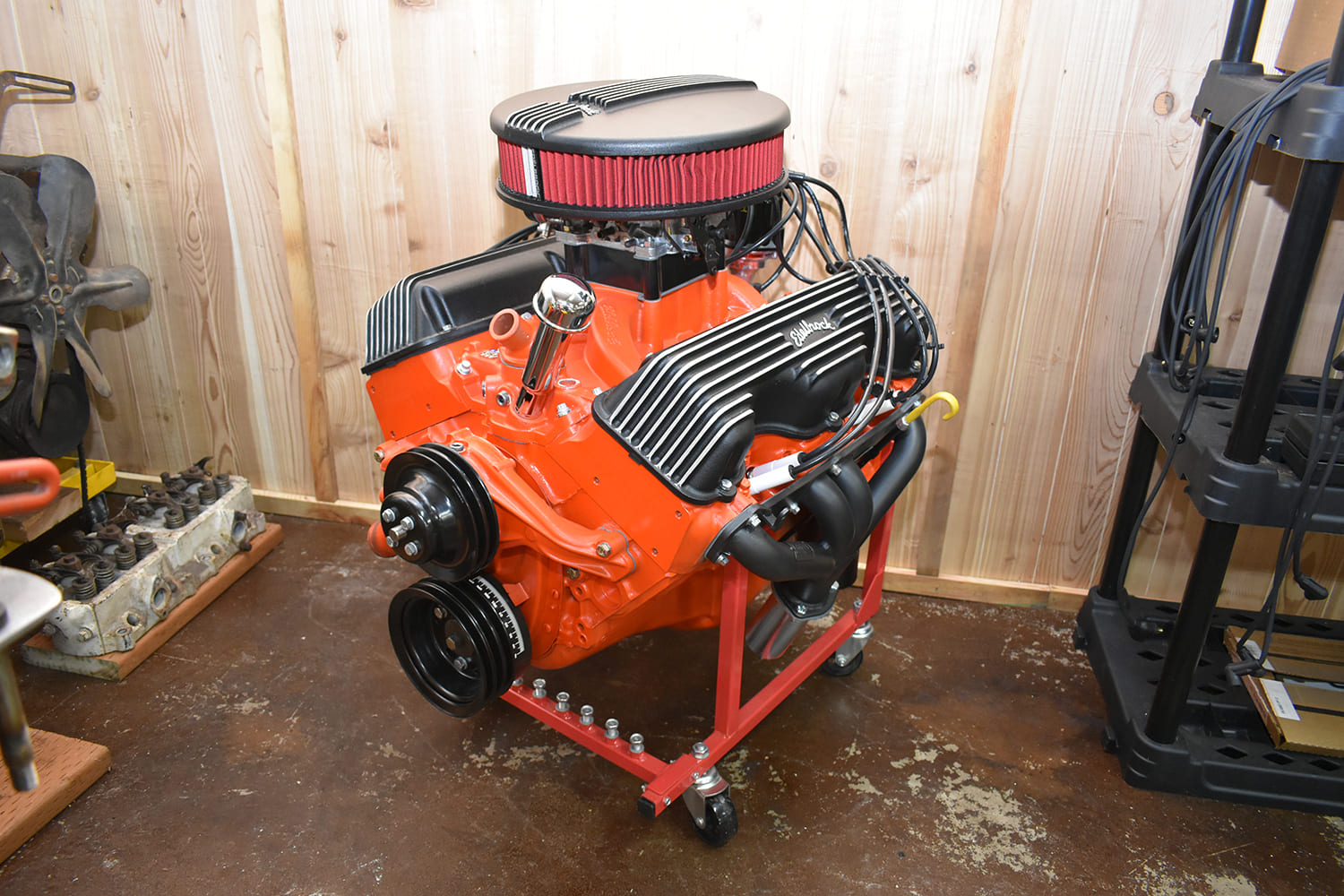 Edelbrock 409 engine painted chevy orange with finned valve covers.