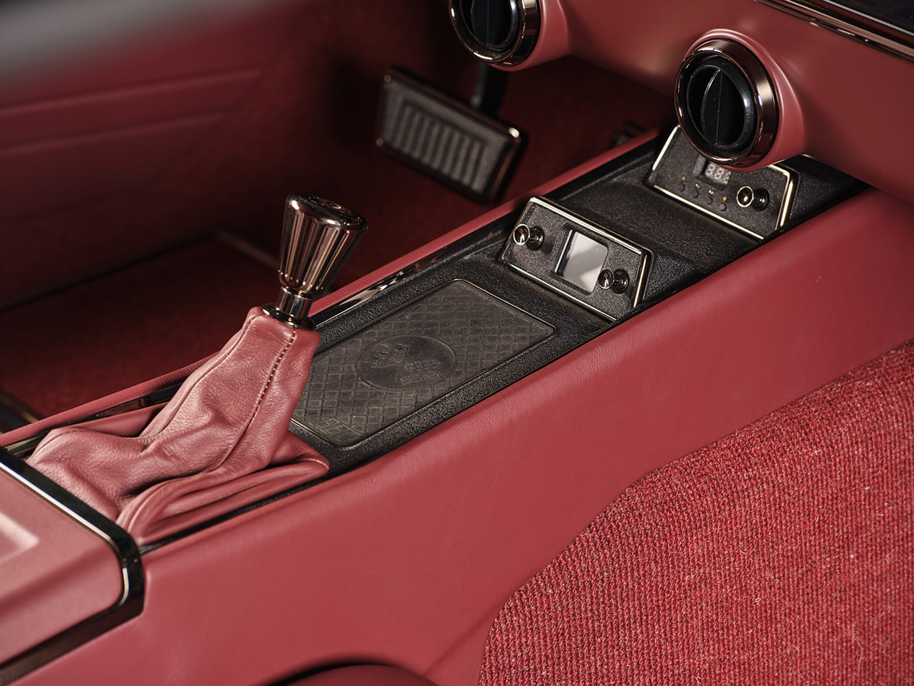 1959 Chevrolet Impala interior center console close up red leather manual shifter custom controls classic coupe