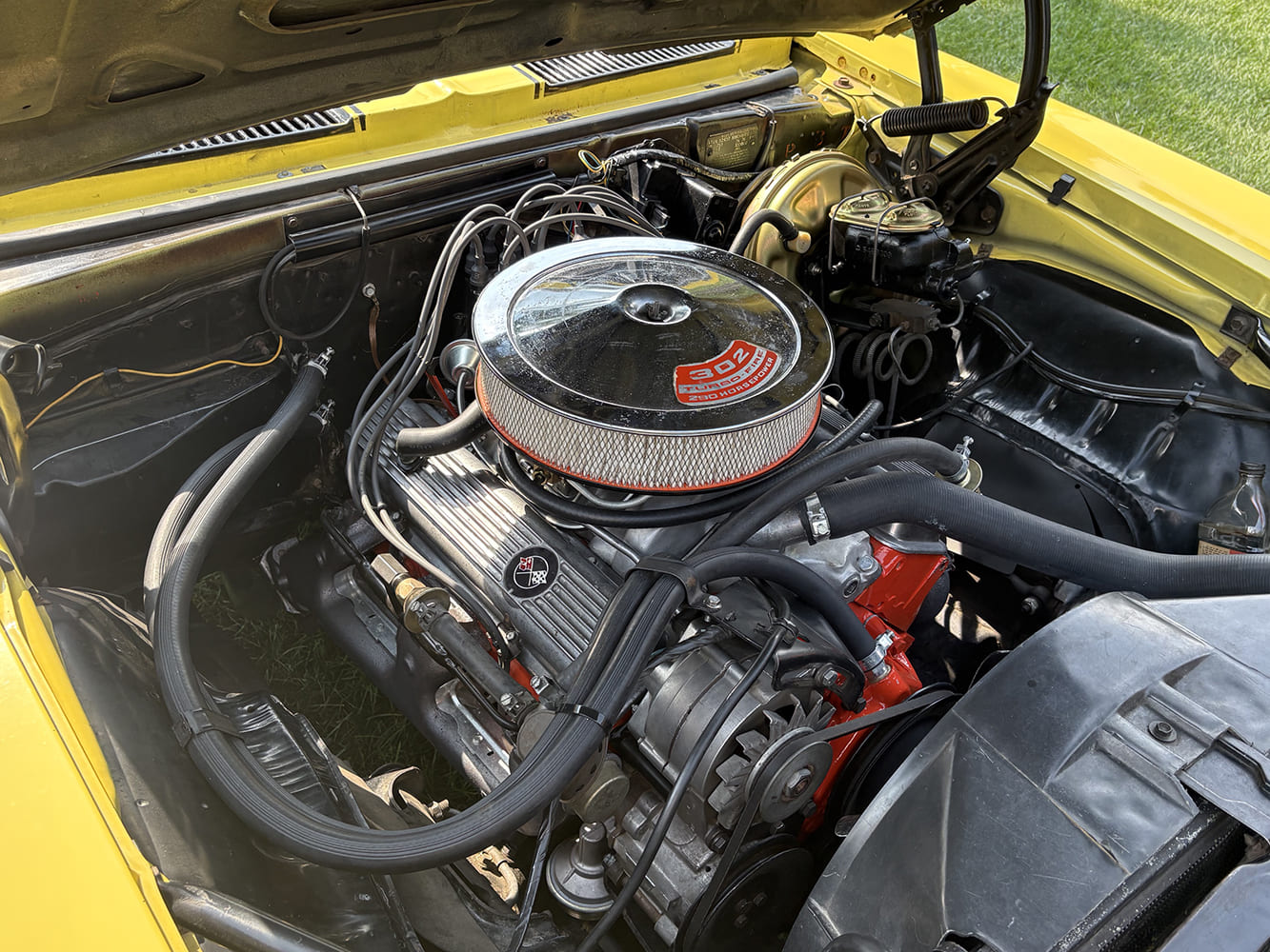 Overhead close-up of a factory-correct DZ 302 cubic inch Turbo-Fire V8 engine in a 1969 Chevrolet Camaro Z28.