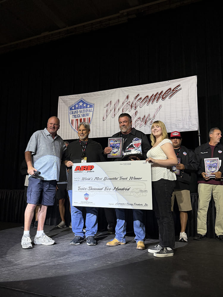 Award presentation ceremony on stage with the winners holding an ARP $12,500 check and custom award trophies in front of the Grand National Truck Show banner.