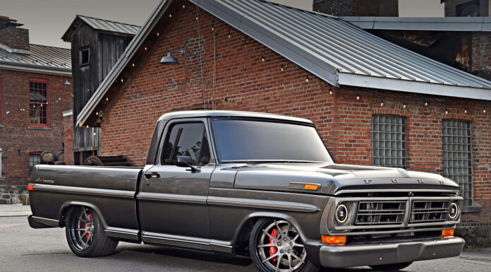 Dylan Keindl’s Restored 1972 F-100 Ford Bumpside Low front three-quarter angle of a custom metallic gray 1972 Ford F-100 pickup showing large Wilwood disc brakes behind brushed wheels.