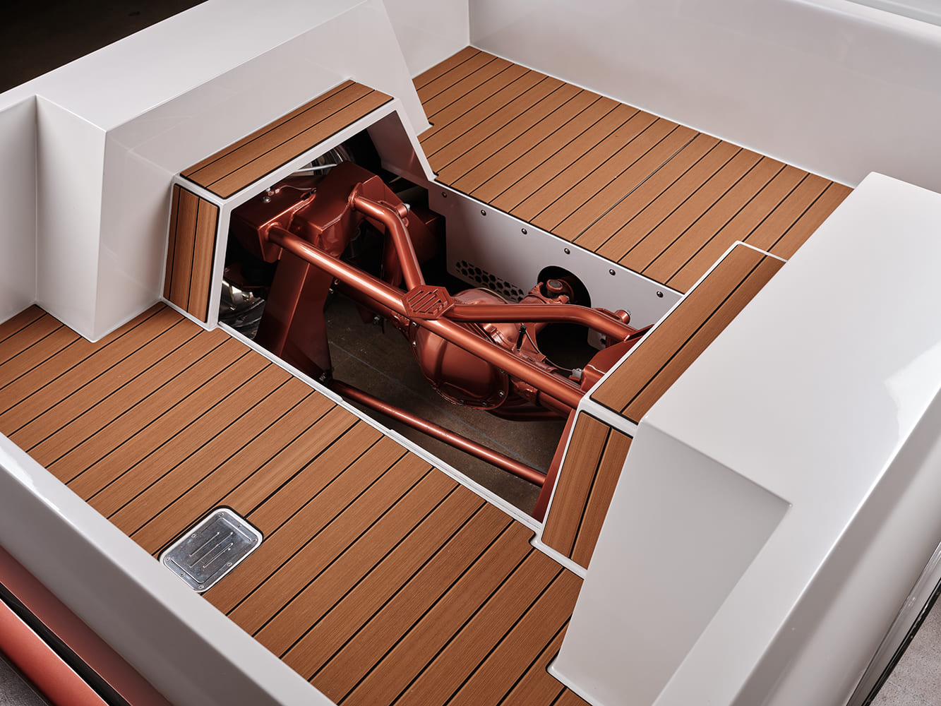Overhead look into the custom white truck bed featuring wood plank flooring with a cutout displaying the copper-painted multi-link rear suspension and axle.