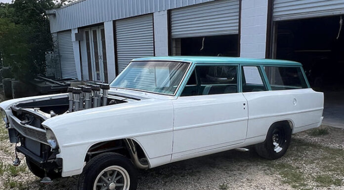 1966 Nova Gasser Build Front three-quarter view of a white 1966 Chevy II Nova wagon gasser featuring a turquoise roof, straight front axle, tall velocity stacks, and American Racing wheels parked outside a workshop.