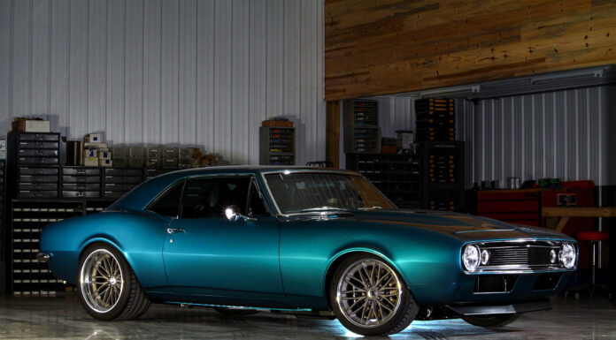 Pro Touring Style 1967 Camaro Front three-quarter view of a teal metallic pro-touring 1967 Chevrolet Camaro parked on a polished shop floor.