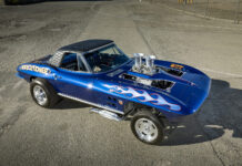 Wild Historical Gasser-Style 1964 Corvette High-angle view of a blue 1964 Corvette gasser showing the diamond-stitched vinyl roof and dual velocity stacks through the hood.