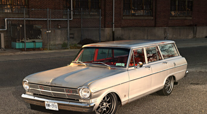 1962 Chevy Nova Wagon Restomod High front three-quarter perspective of a 1962 Chevrolet Nova station wagon showing the sunlit patina hood, chrome front bumper, and lowered pro-touring stance.