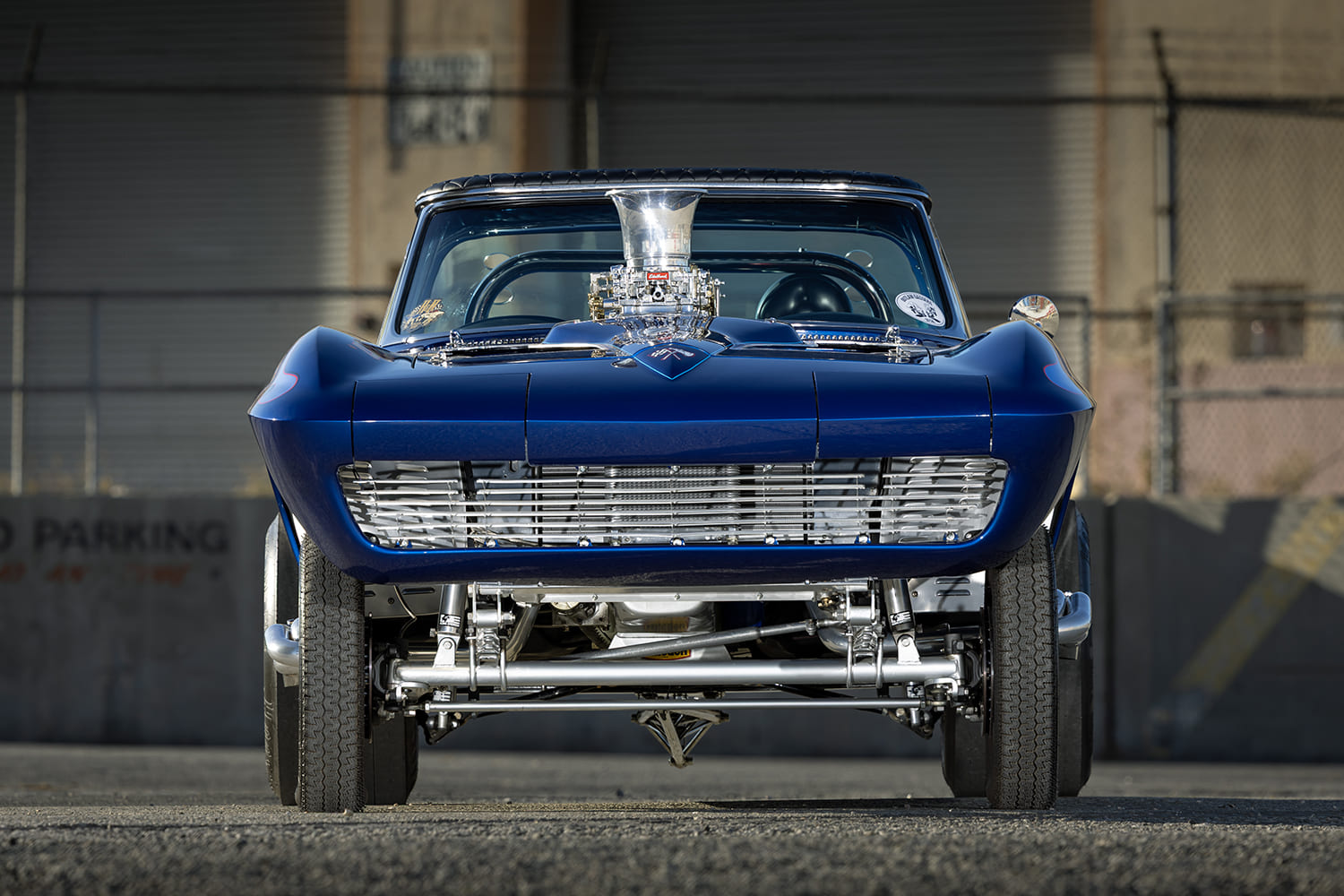 Head-on front view of a 1964 Corvette gasser highlighting the polished straight tube axle suspension and custom tube grille.