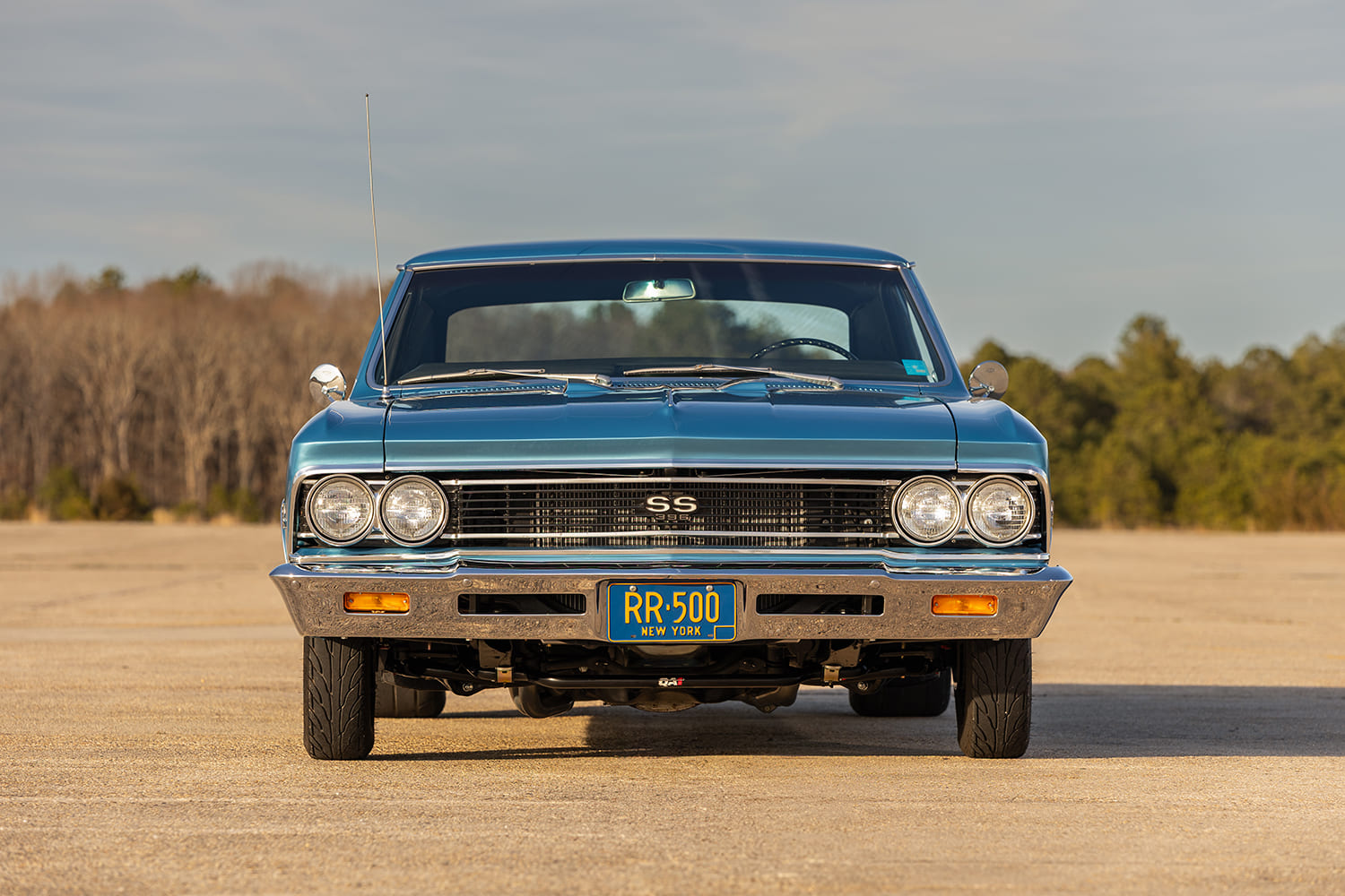 Head-on symmetrical view of the 1966 Chevelle SS highlighting the blacked-out SS grille, chrome bumper, amber turn signals, and QA1 front suspension components visible below.