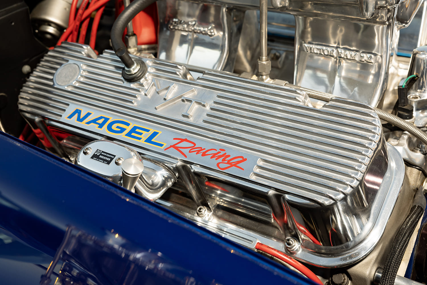 Close-up of a polished finned Mickey Thompson valve cover with custom Nagel Racing lettering and Moon breather cap.