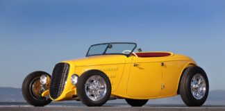 Front three-quarter view of the yellow 1934 Ford AMBR contender featuring custom horizontal grille and open front wheels.