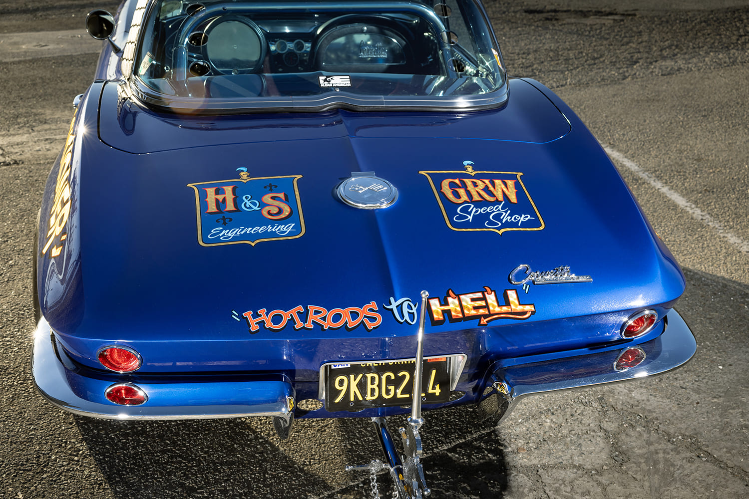 Rear view of the decklid featuring hand-lettered H&S Engineering, GRW Speed Shop, and Hot Rods to Hell logos above a chrome executioner axe mount.