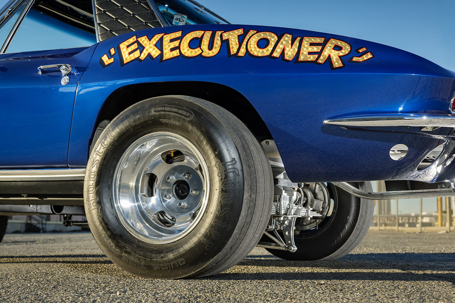 Close-up side perspective of the gold-leaf Executioner lettering on the rear quarter panel and deep-dish polished wheel with Hoosier slick.