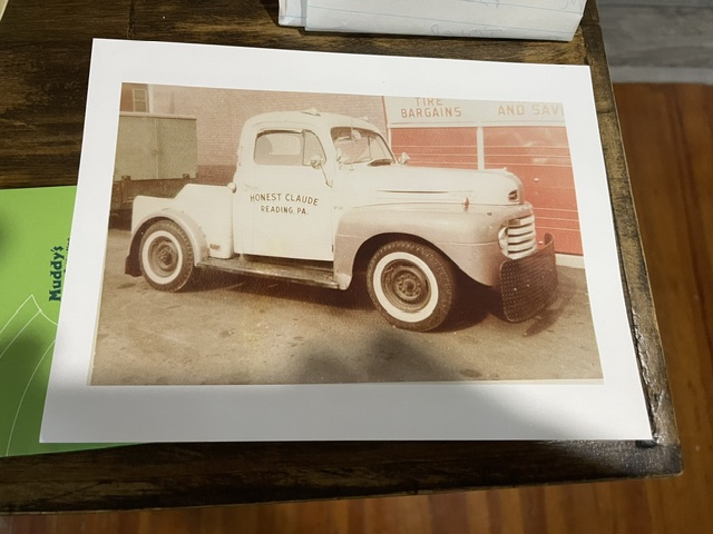 Archival vintage color photo print showing the original white 1949 Ford F2 wrecker lettered "Honest Claude Reading, PA" with whitewall tires.