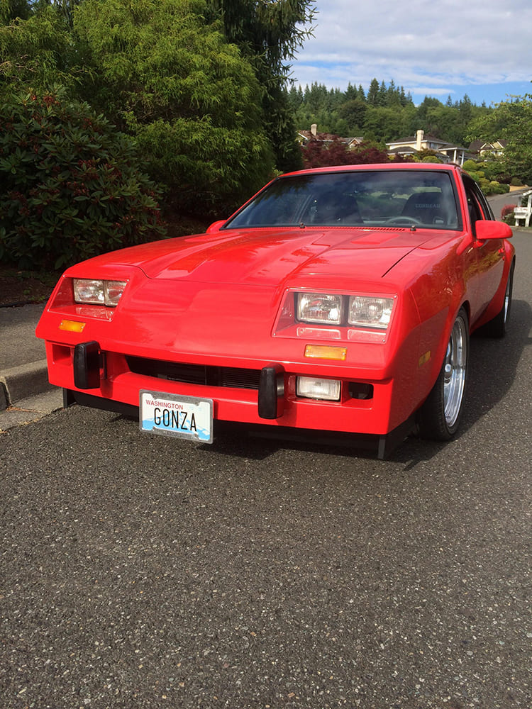 Low-angle straight-on front shot of the 1975 Chevy Monza featuring a hand-molded fiberglass front air dam, lower spoiler, and quad rectangular headlights.