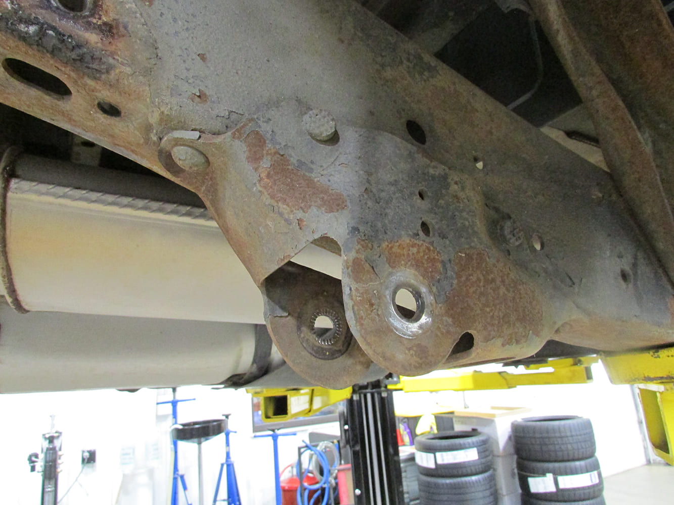 Underside view of stock Chevy S-10 suspension forward leaf spring frame hanger prior to installing aftermarket components.