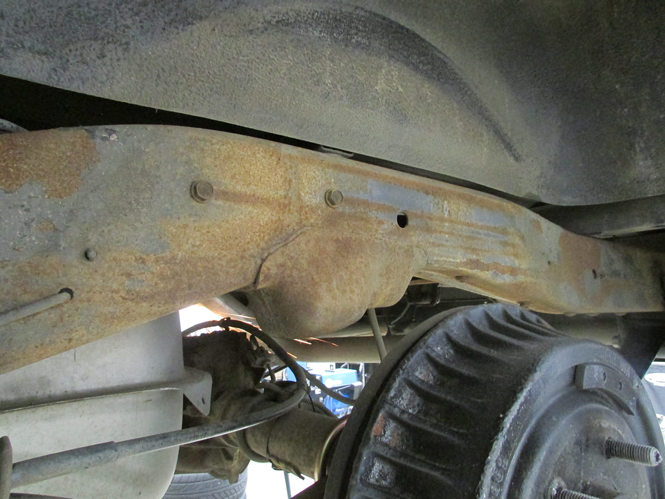 Factory Chevrolet S-10 rear frame rail section over the axle and drum brake prior to frame notch modification.
