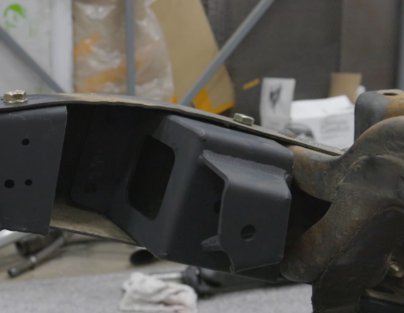 est-fitting the Detroit Speed upper link mounting bracket inside the notched Chevy S-10 suspension frame rail.