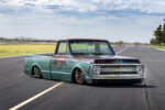 Arizona High Test–built 1969 Chevy C10 Low-angle front three-quarter view of a bagged patina turquoise and brown 1969 Chevrolet C10 pickup laid out on airport runway tarmac.