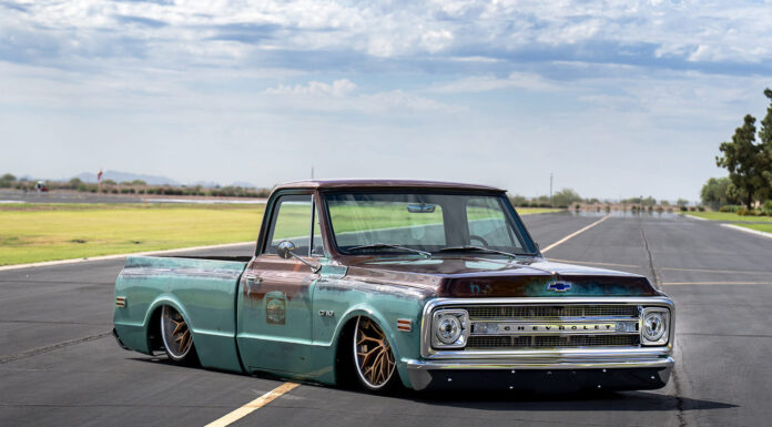 Arizona High Test–built 1969 Chevy C10 Low-angle front three-quarter view of a bagged patina turquoise and brown 1969 Chevrolet C10 pickup laid out on airport runway tarmac.