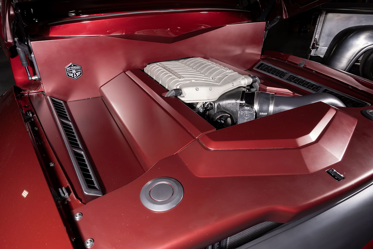 Direct overhead view of the custom body-color sheetmetal engine bay enclosure surrounding a Whipple-supercharged Ford Coyote 5.0L V8.