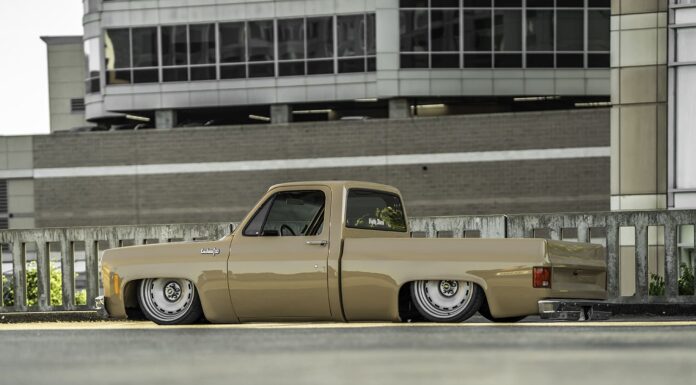 Darren Harden’s 1973 Chevy Squarebody Low driver-side ground-level profile of Darren Harden’s 1973 Chevy Squarebody sitting completely flat on the asphalt with both 22-inch steelies tucked.